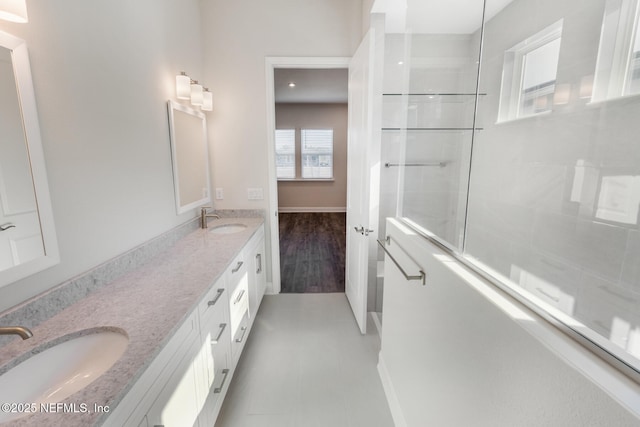 bathroom with tile patterned flooring, a sink, and double vanity