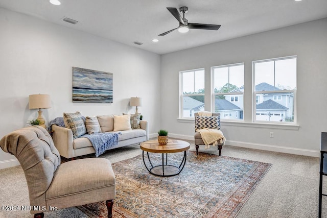 carpeted living room featuring ceiling fan