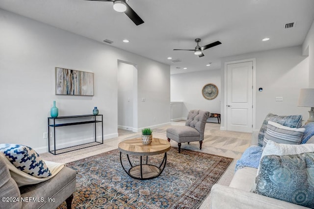 carpeted living room with ceiling fan