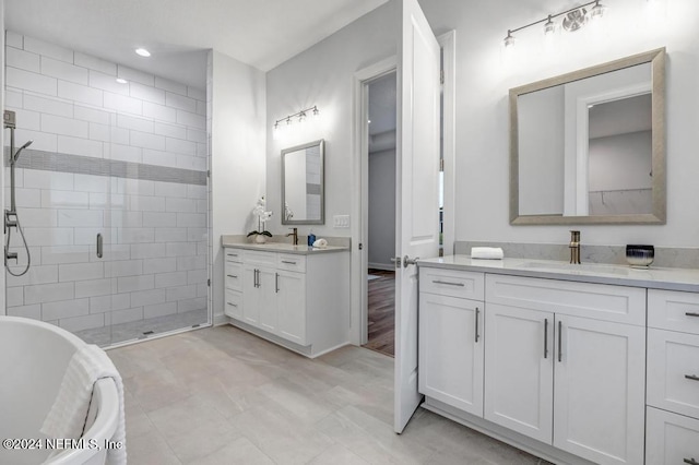 bathroom with vanity and shower with separate bathtub