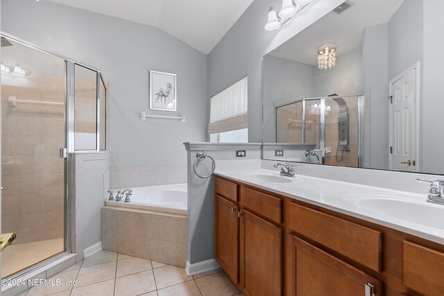 bathroom with a stall shower, tile patterned flooring, a sink, and visible vents