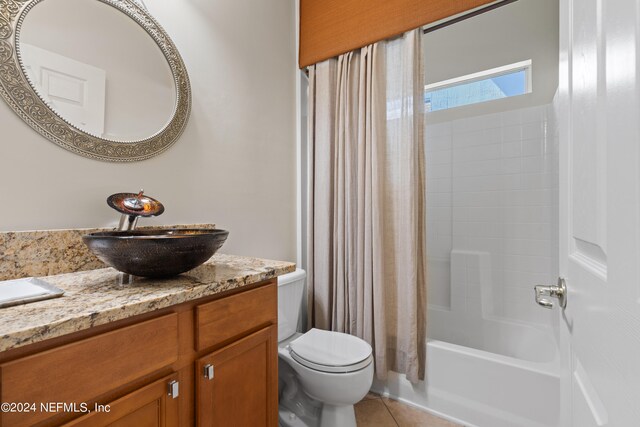 full bathroom featuring vanity, shower / bath combo, tile patterned flooring, and toilet