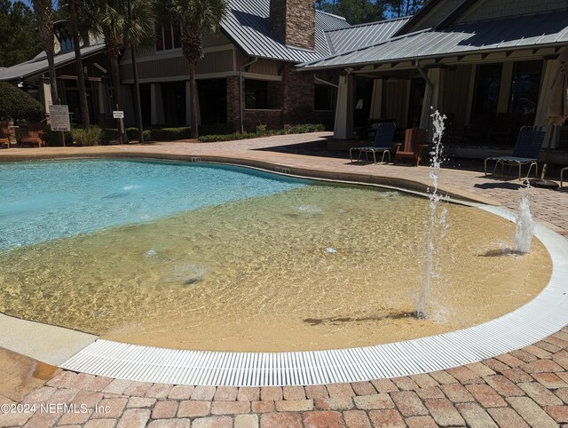 community pool featuring a patio area