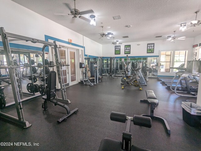 gym with a textured ceiling, french doors, visible vents, and a ceiling fan