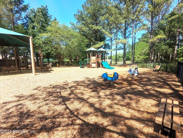 communal playground featuring fence