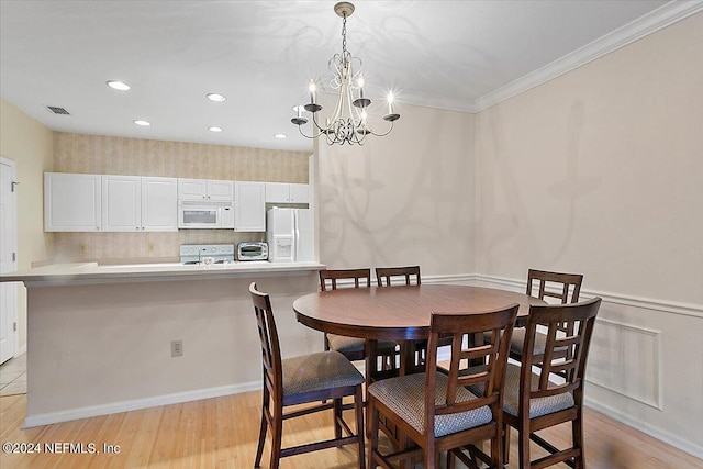 dining area featuring light wood-type flooring and an inviting chandelier