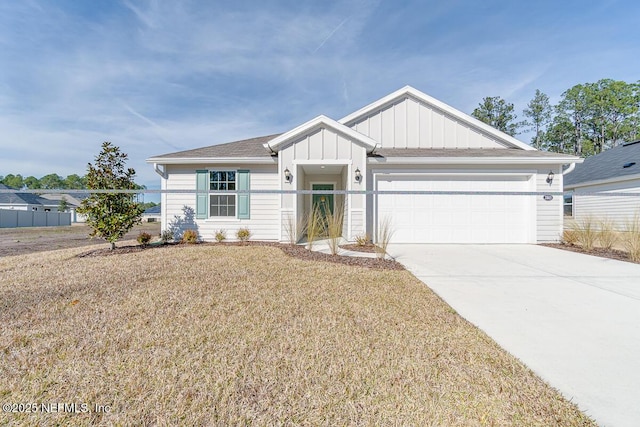 view of front of house with a garage and a front yard