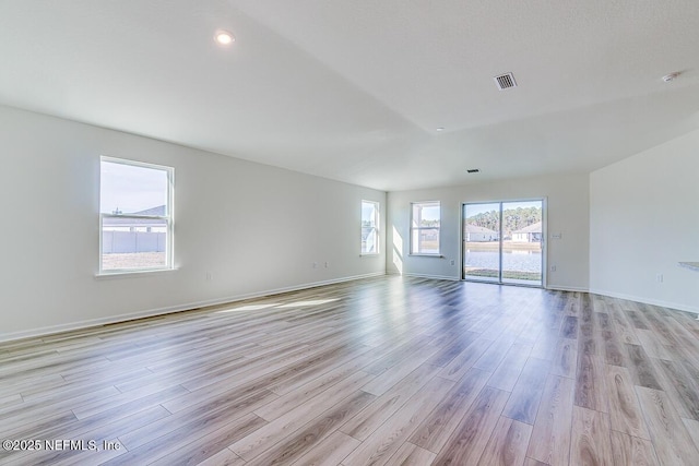 unfurnished room with light wood-type flooring