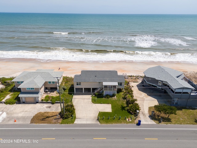 birds eye view of property featuring a water view and a view of the beach