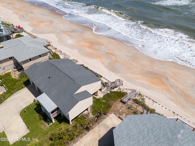 birds eye view of property featuring a water view and a beach view