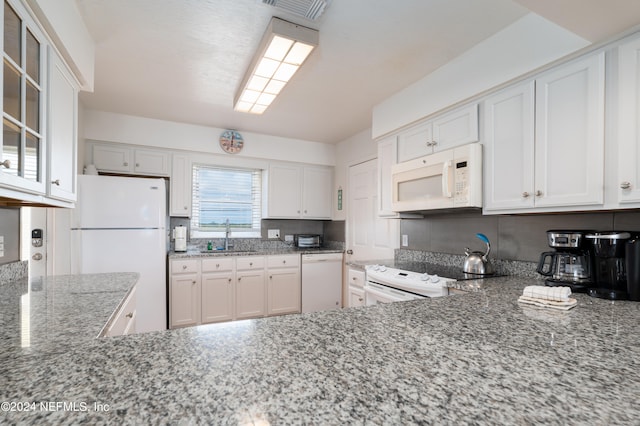 kitchen with white cabinets, sink, and white appliances