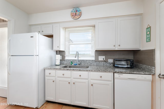 kitchen with plenty of natural light, white appliances, and sink