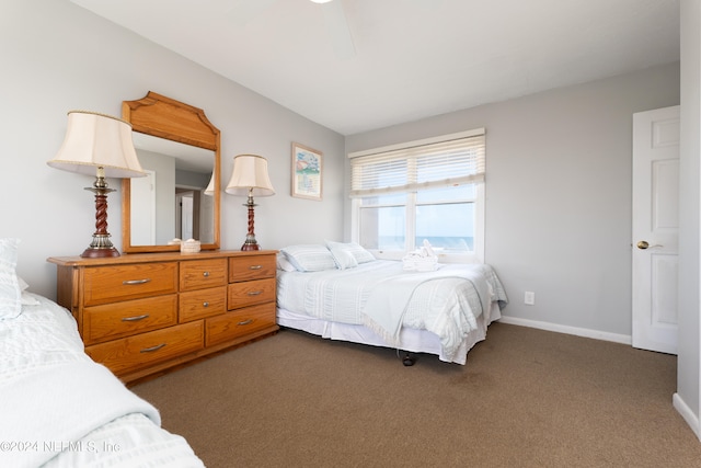 bedroom featuring dark colored carpet and ceiling fan