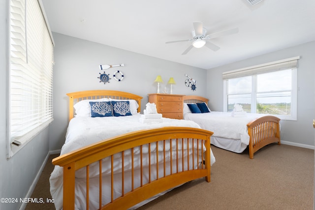 carpeted bedroom featuring ceiling fan