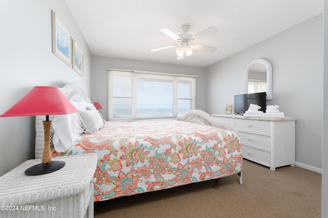 bedroom featuring ceiling fan and carpet