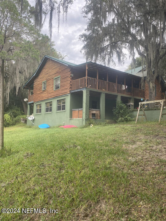 back of house with a lawn