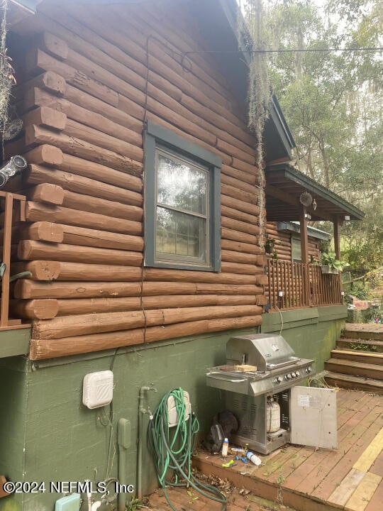 view of property exterior featuring a wooden deck