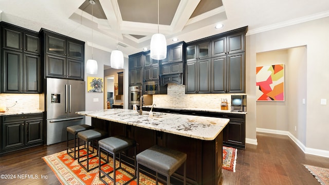 kitchen featuring hanging light fixtures, stainless steel appliances, crown molding, dark hardwood / wood-style floors, and an island with sink