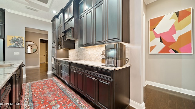 kitchen featuring crown molding, dark wood-type flooring, light stone counters, tasteful backsplash, and black electric cooktop