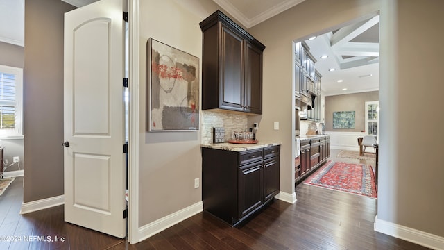 bar with dark brown cabinets and dark hardwood / wood-style flooring