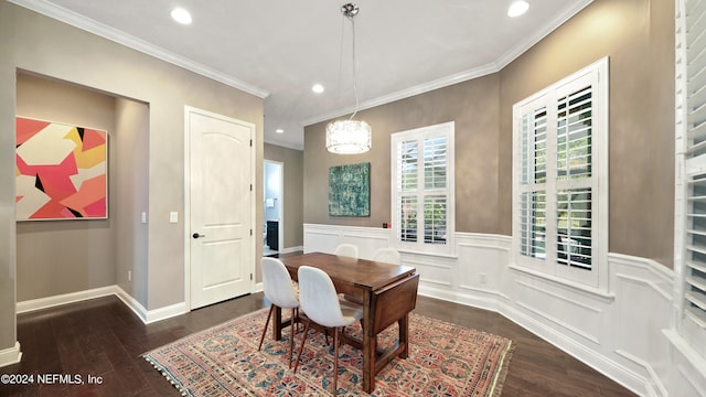 dining space featuring crown molding, a chandelier, and dark wood-type flooring