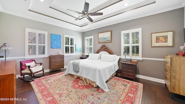 bedroom featuring ceiling fan, dark hardwood / wood-style floors, and multiple windows