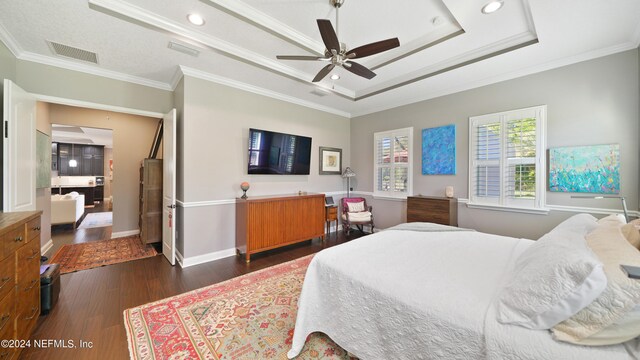 bedroom featuring ornamental molding, dark hardwood / wood-style flooring, ceiling fan, and a raised ceiling