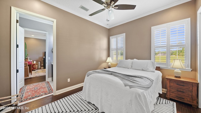 bedroom featuring ceiling fan, dark wood-type flooring, and ornamental molding