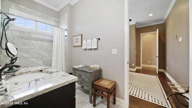 bathroom featuring ornamental molding, vanity, and hardwood / wood-style flooring