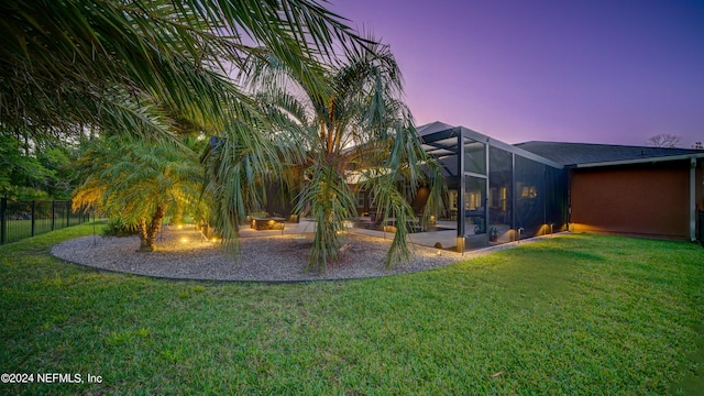 yard at dusk with a patio and a lanai