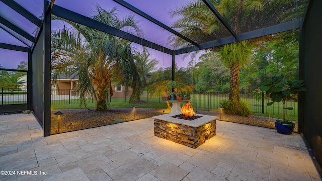 patio terrace at dusk featuring an outdoor fire pit