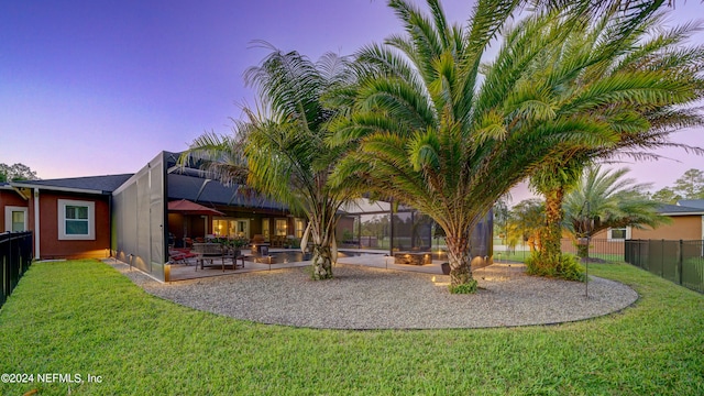 yard at dusk featuring a patio