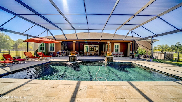 view of swimming pool with a patio area, pool water feature, and a lanai