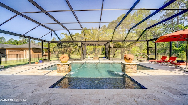 view of pool featuring a patio area, pool water feature, an outdoor hot tub, and glass enclosure