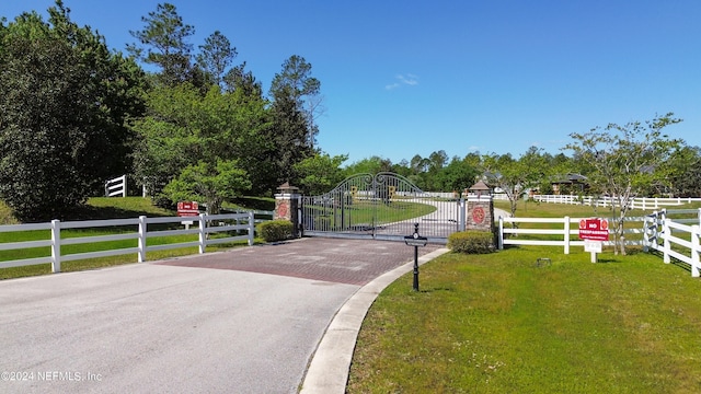 view of gate featuring a yard