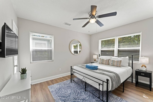 bedroom featuring hardwood / wood-style floors and ceiling fan