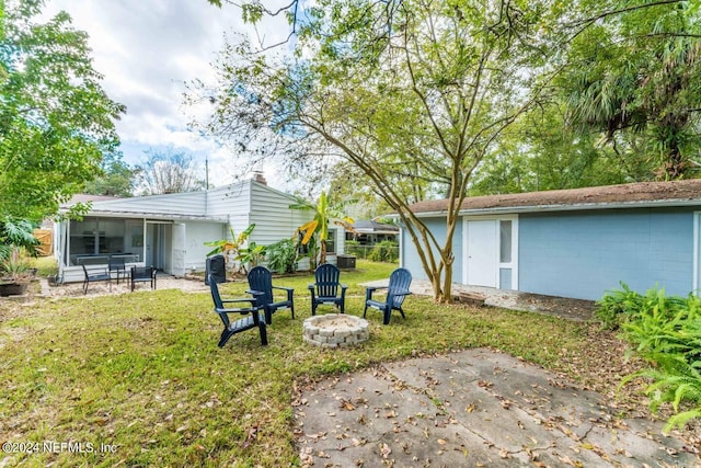 view of yard with a patio area and an outdoor fire pit