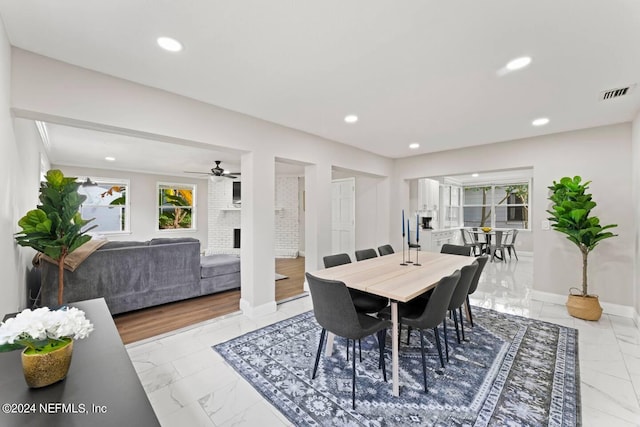 dining room featuring ceiling fan and light tile flooring