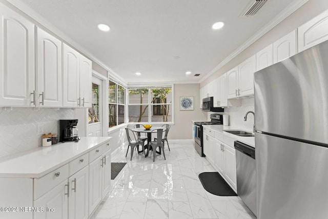 kitchen featuring appliances with stainless steel finishes, light tile floors, white cabinets, sink, and backsplash