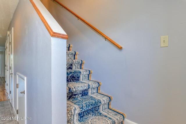 stairway featuring light tile floors