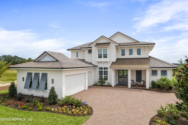 view of front of house featuring a garage and a porch