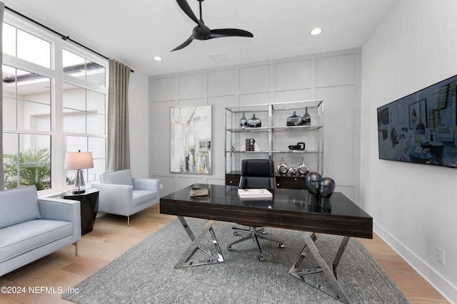 office with ceiling fan and light wood-type flooring