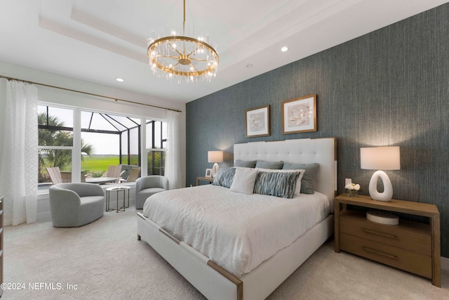 bedroom with an inviting chandelier, light carpet, and a tray ceiling