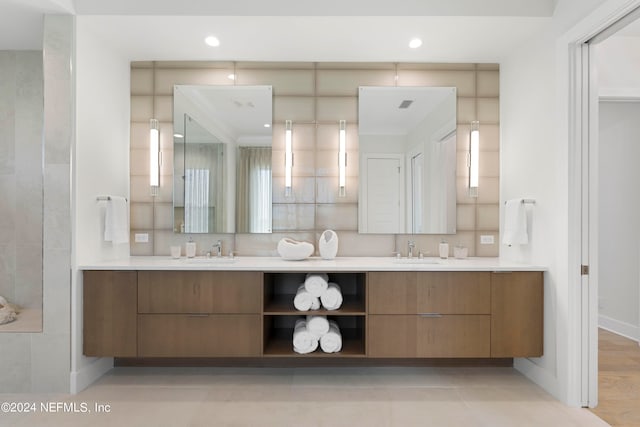 bathroom with dual bowl vanity and tile flooring