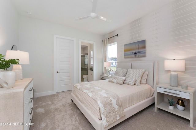 carpeted bedroom with connected bathroom and ceiling fan