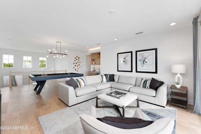 living room featuring light hardwood / wood-style flooring and a chandelier