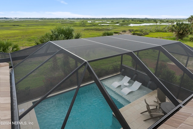 view of pool featuring a rural view, a lanai, and a patio