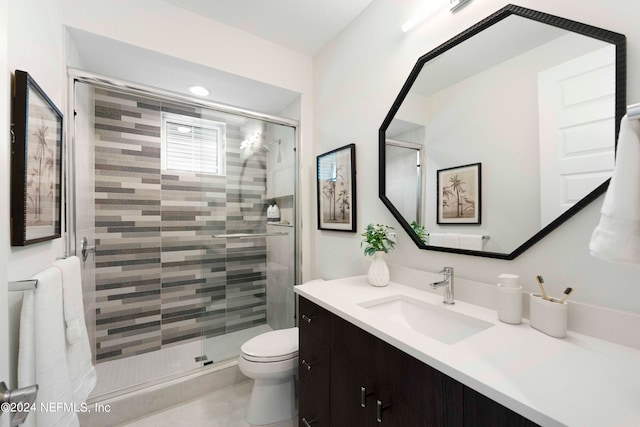 bathroom with oversized vanity, an enclosed shower, and toilet