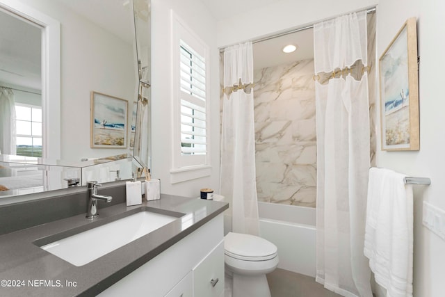 full bathroom featuring shower / tub combo with curtain, vanity, and toilet