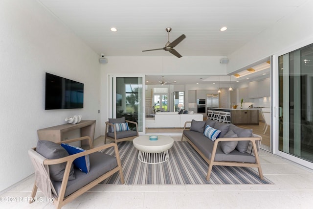 living room featuring ceiling fan and sink